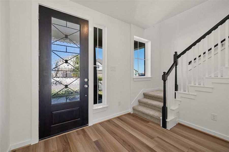 Entryway with wood finished floors and stairs Entryway with wood finished floors and stairs