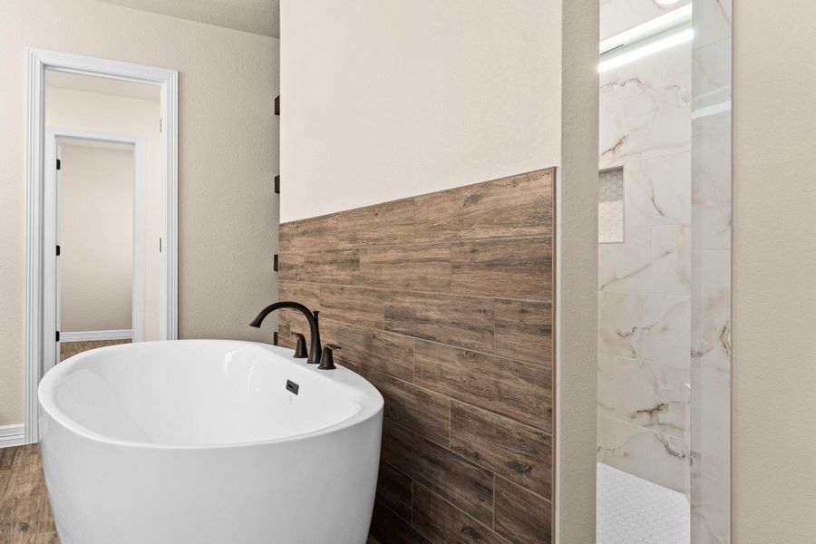 Full bath with a freestanding bath and a marble finish walk-in shower Full bath with a freestanding bath and a marble finish walk-in shower