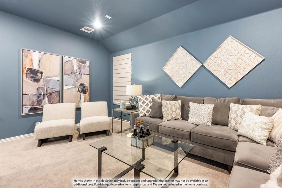 Living room with gray sectional sofa, glass coffee table, two accent chairs, and blue-gray walls with decorative art panels.