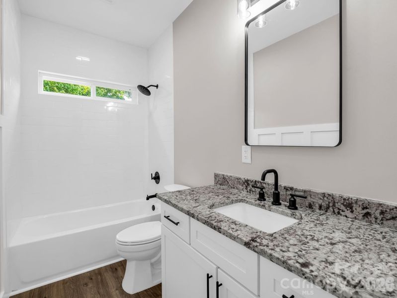 Guest Bath between bedrooms 2 & 3, granite counters, hardwood floors, opposite wall offers a beautiful wainscoting wall. Guest Bath between bedrooms 2 & 3, granite counters, hardwood floors, opposite wall offers a beautiful wainscoting wall.