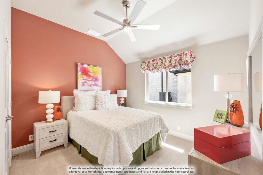 Bedroom with vaulted ceiling, ceiling fan, coral accent wall, and carpet flooring