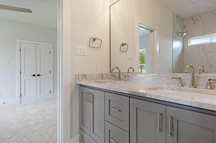 Bathroom featuring double vanity and plenty of natural light