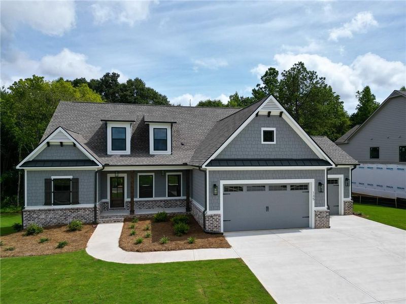 Front exterior of a new home in Riverwalk, Monroe, GA, highlighting curb appeal (Image 1). Front exterior of a new home in Riverwalk, Monroe, GA, highlighting curb appeal (Image 1).