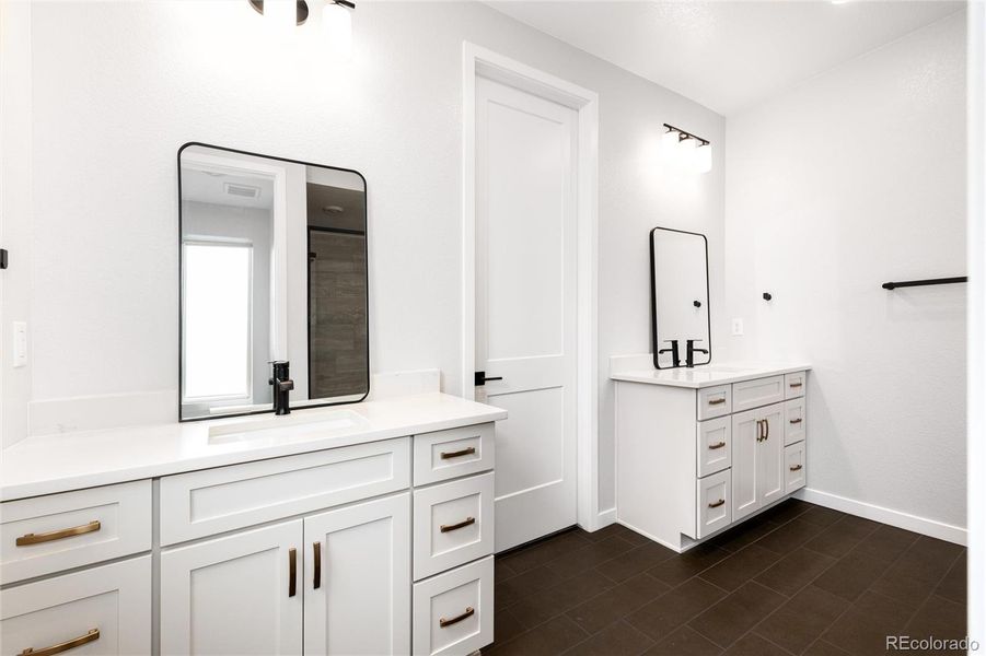 Primary ensuite with dual vanities. Same upscale finishes and features.