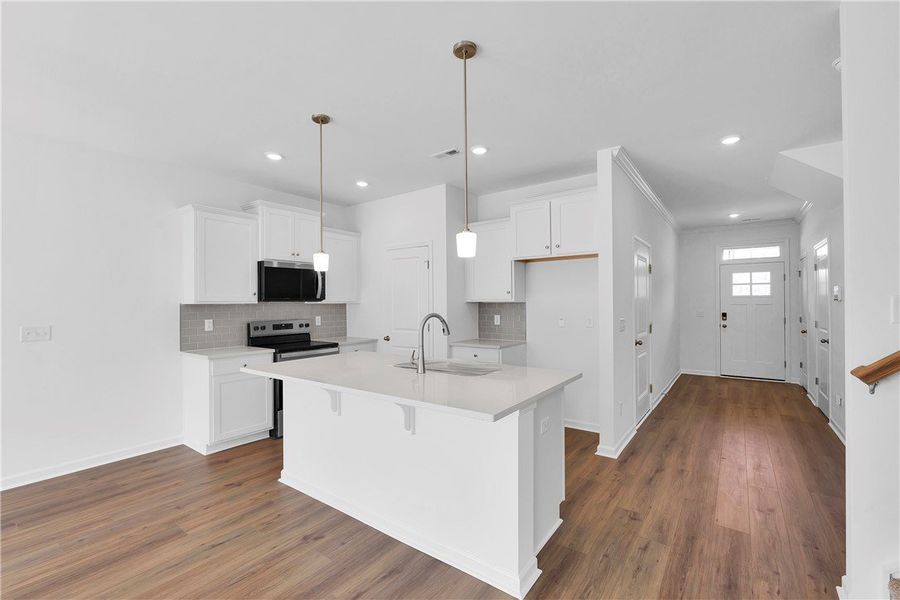 This bright kitchen features an island, ample cabi This bright kitchen features an island, ample cabi