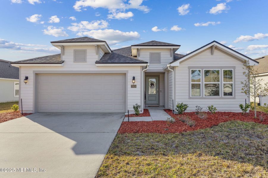 Front exterior of a new home in River Glen, Yulee, FL, highlighting curb appeal (Image 22). Front exterior of a new home in River Glen, Yulee, FL, highlighting curb appeal (Image 22).