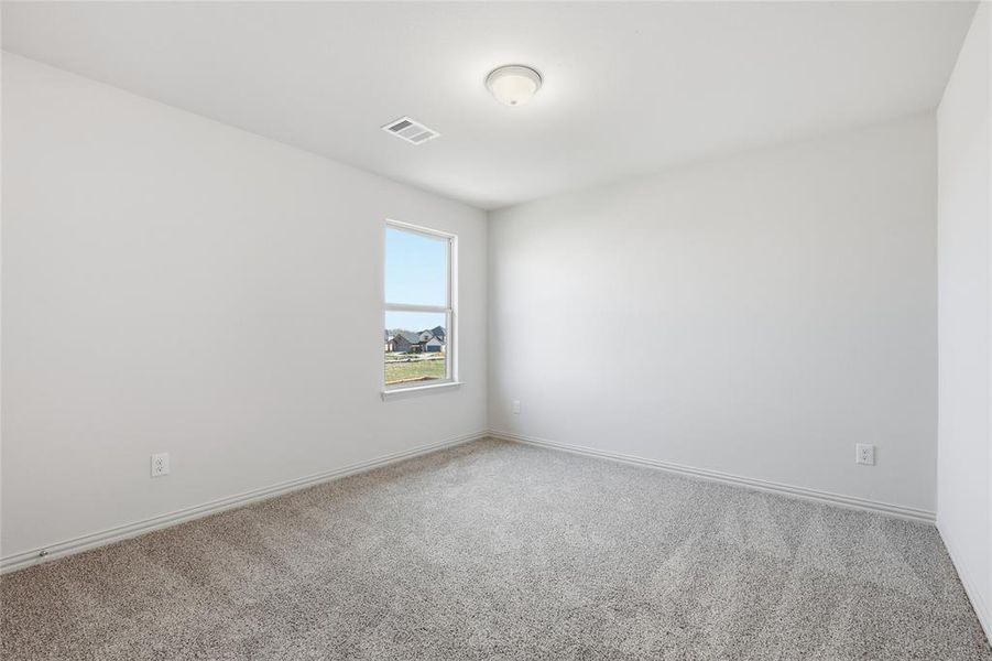 Neutral white walls complement light gray carpet flooring