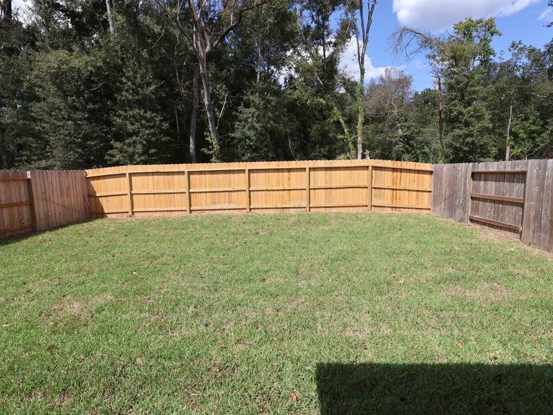 Exterior details and patio area of a home in Pinewood at Grand Texas, New Caney (Image 9). Exterior details and patio area of a home in Pinewood at Grand Texas, New Caney (Image 9).