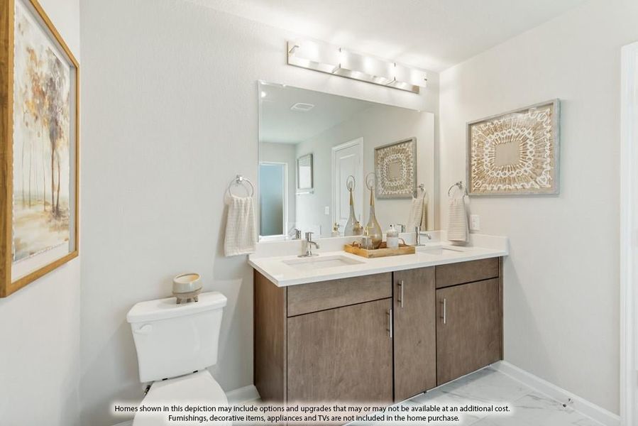 Bathroom with double-sink vanity, dark wood cabinets, white countertop, and large mirror with overhead lighting