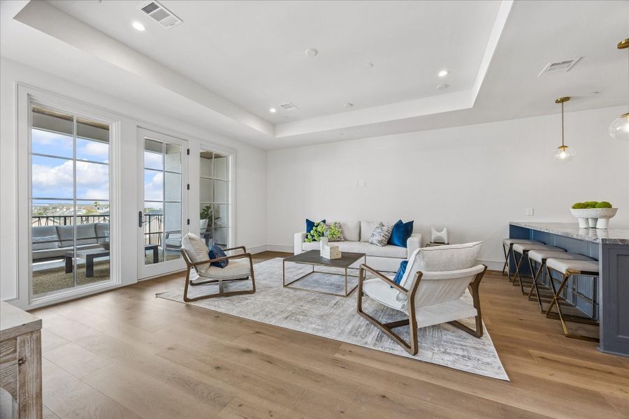 The fourth floor boasts a generous City Room, perfect for entertaining or relaxing. The tray ceiling helps define the space and creates distinction between the room and the wet bar.