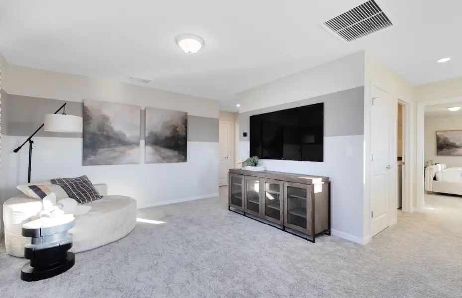 Representative furnished interior of a home built from the Mabel II by Pulte Homes in EverBe, Orlando (Image 6).