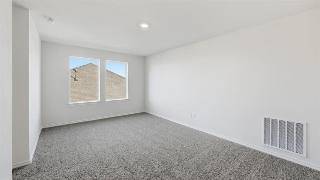 Carpeted empty room featuring baseboards