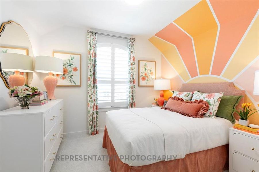 Bedroom with light colored carpet and baseboards