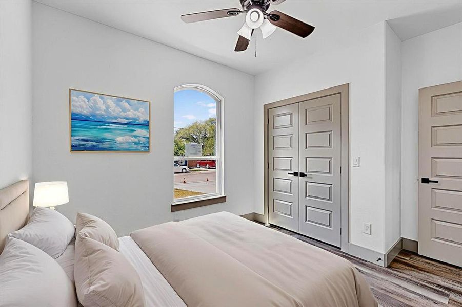 Bedroom with wood finished floors, a closet, and a ceiling fan