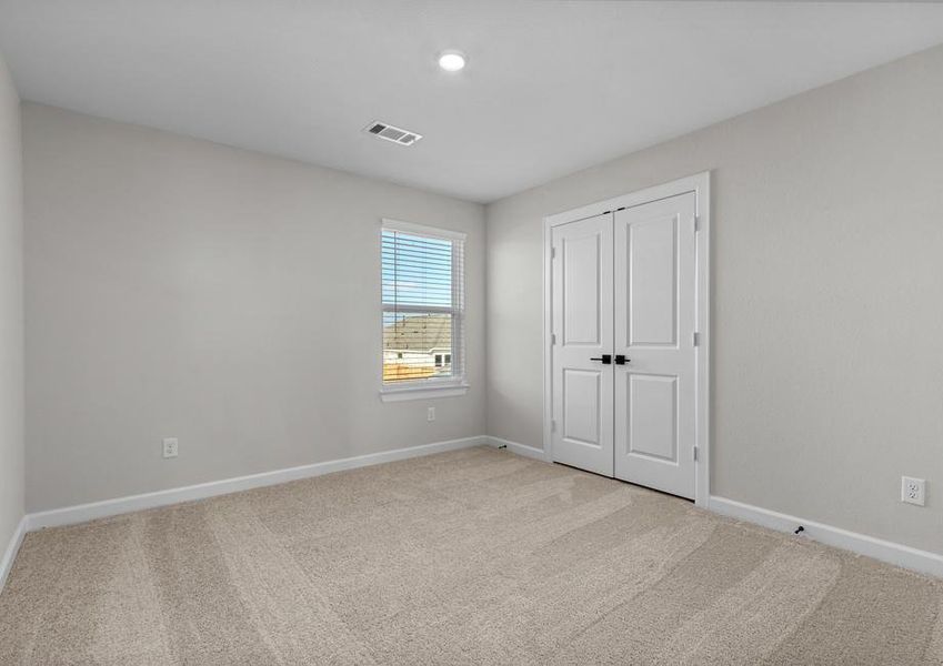 Windows let in plenty of light to this secondary bedroom.