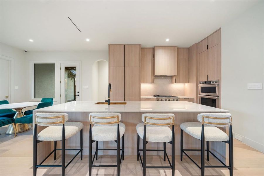 This gourmet kitchen practically begs the chef in the family to step in and put all the amenities to good use for the holidays, and every day! Quartzite counters expertly showoff the custom storage cabinets.