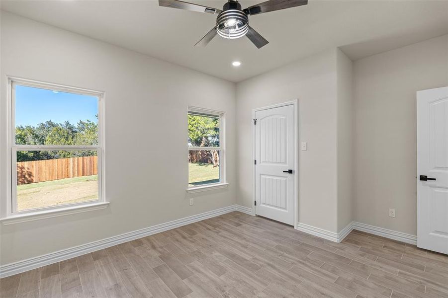 Unfurnished bedroom with light hardwood / wood-style flooring and ceiling fan