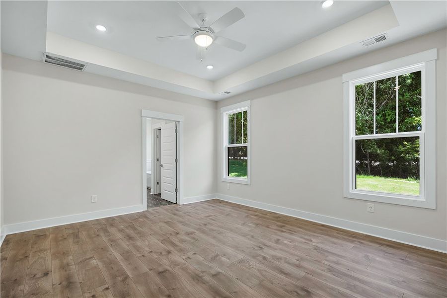 Well-lit sleeping quarters with a ceiling fan, rec