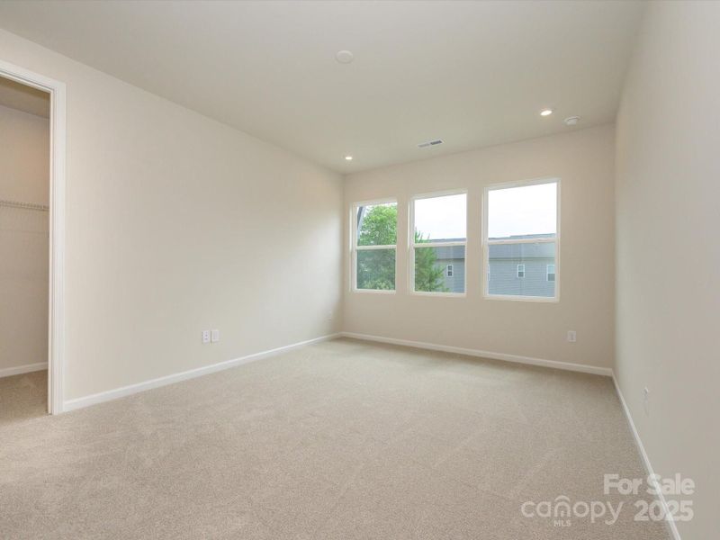 Large primary suite with large windows and seeped in natural light. Large primary suite with large windows and seeped in natural light.