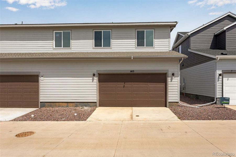 Front exterior of a new home in Sugar Mill Village, Longmont, CO, highlighting curb appeal (Image 17). Front exterior of a new home in Sugar Mill Village, Longmont, CO, highlighting curb appeal (Image 17).