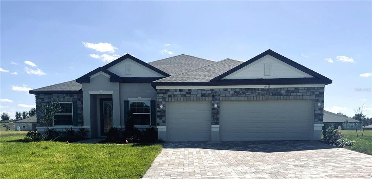 Front exterior of a new home in Graceland Estates, Thonotosassa, FL, highlighting curb appeal (Image 2). Front exterior of a new home in Graceland Estates, Thonotosassa, FL, highlighting curb appeal (Image 2).