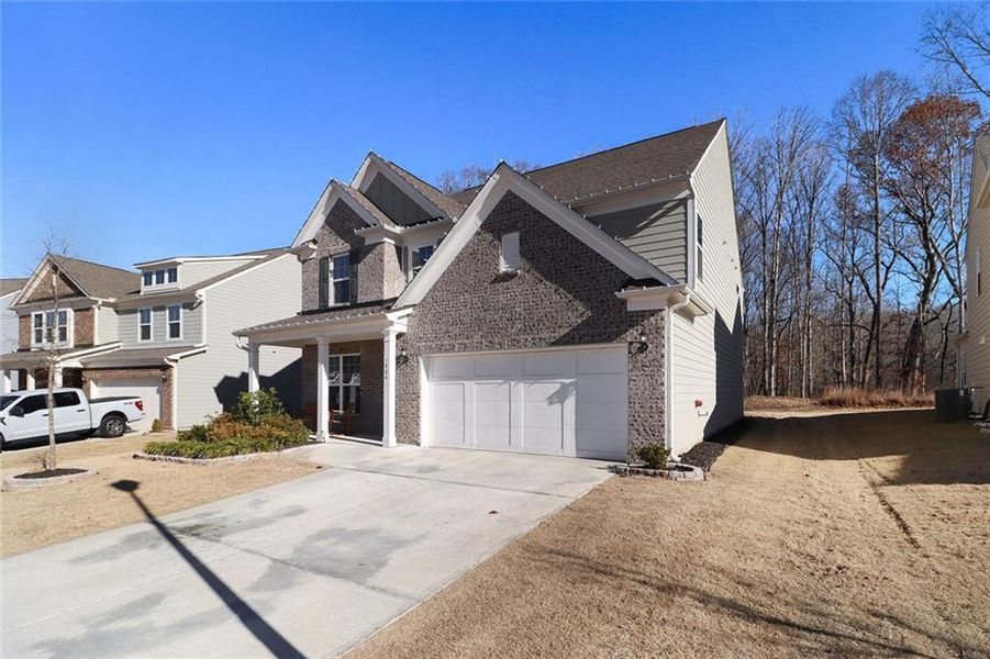 Front exterior of a new home in Pinebrook at Hamilton Mill, Auburn, GA, highlighting curb appeal (Image 24). Front exterior of a new home in Pinebrook at Hamilton Mill, Auburn, GA, highlighting curb appeal (Image 24).