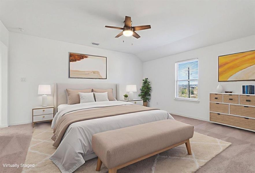 Bedroom with carpet floors, vaulted ceiling, and a ceiling fan