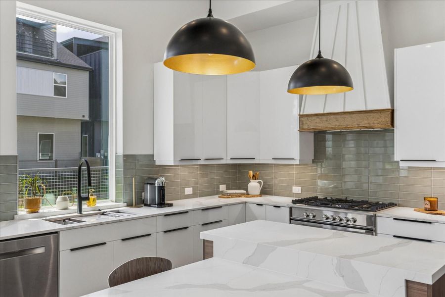 Thoughtfully designed with quartz countertops, full-height cabinetry, and a professional grade gas range. Thoughtfully designed with quartz countertops, full-height cabinetry, and a professional grade gas range.