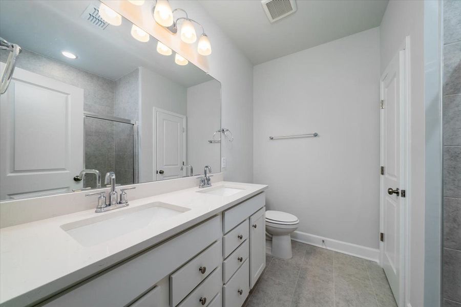 Owner's Bathroom showcases a dual-sink vanity and a shower. Owner's Bathroom showcases a dual-sink vanity and a shower.