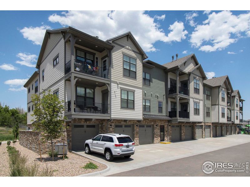 Front exterior of a new home in Highlands at Fox Hill - The Flats, Longmont, CO, highlighting curb appeal (Image 2). Front exterior of a new home in Highlands at Fox Hill - The Flats, Longmont, CO, highlighting curb appeal (Image 2).