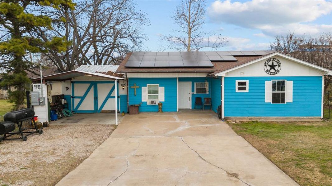 View of front facade featuring solar panels