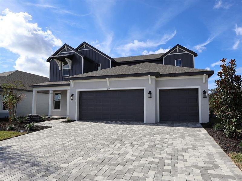 Front exterior of a new home in Creeks Edge at Twin Rivers, Parrish, FL, highlighting curb appeal (Image 1).
