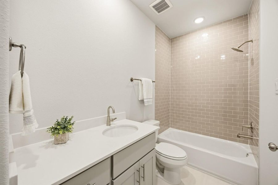 Timeless design and neutral finishes converge in the hall bathroom, crafting an elegant space for daily routines. Timeless design and neutral finishes converge in the hall bathroom, crafting an elegant space for daily routines.