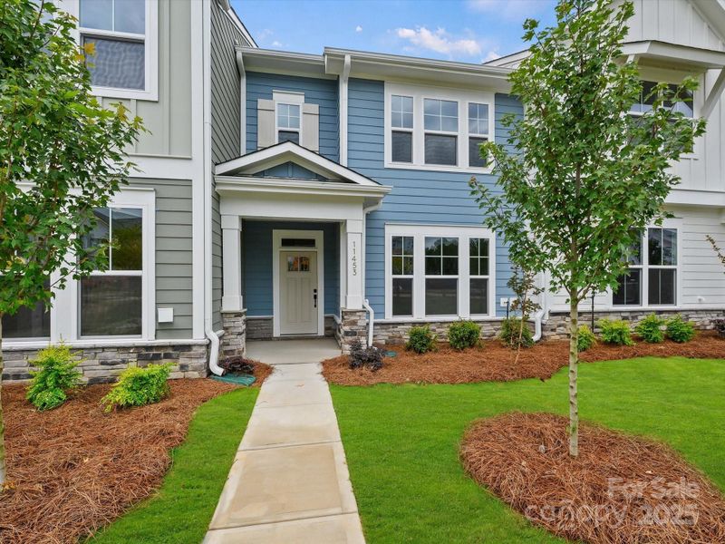 Front exterior of a new home in North Creek Village - Townhomes, Huntersville, NC, highlighting curb appeal (Image 1). Front exterior of a new home in North Creek Village - Townhomes, Huntersville, NC, highlighting curb appeal (Image 1).