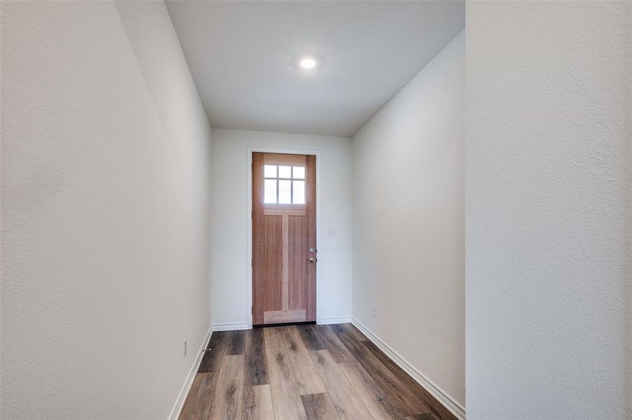 Entryway with dark wood-style flooring and baseboards Entryway with dark wood-style flooring and baseboards