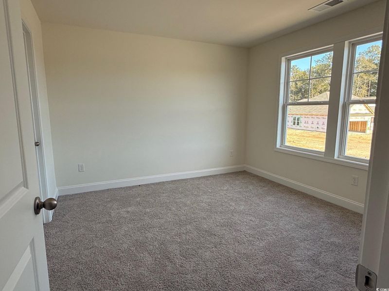 En suite bedroom with walk in closet and full bath