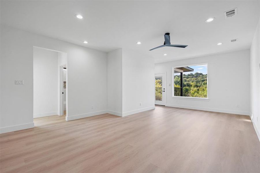 Empty room with recessed lighting, light wood finished floors, and ceiling fan