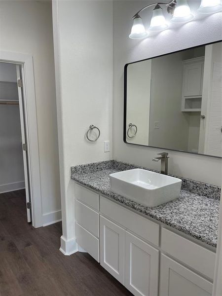 Bathroom with vanity and hardwood / wood-style floors