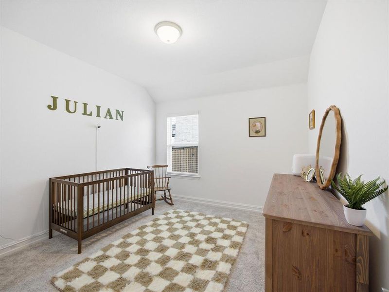 Guest bedroom view of single story three bedroom home with an office and a formal dining room