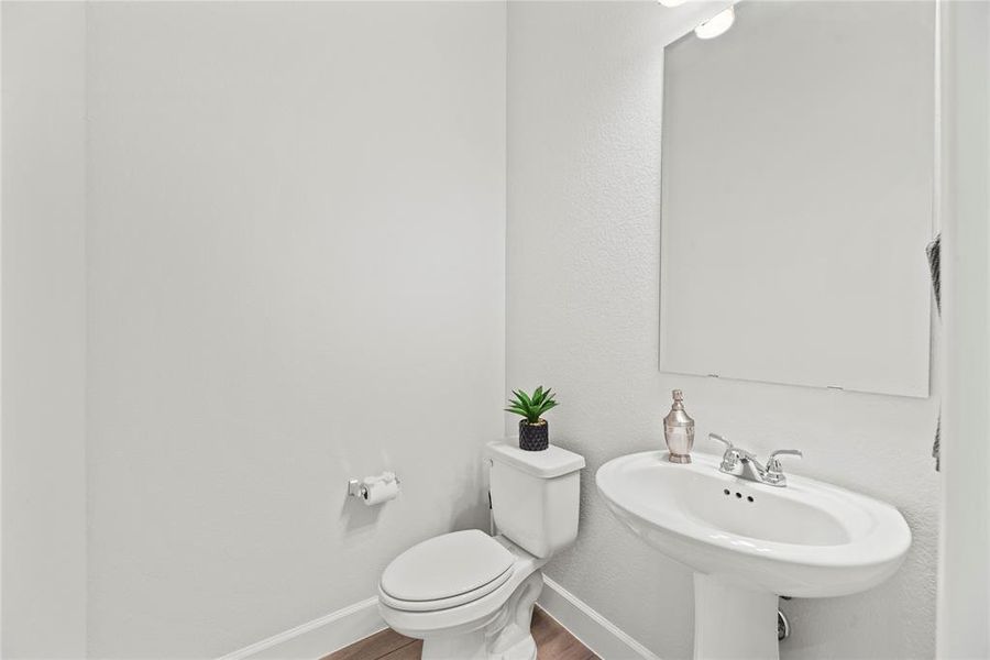 Half bathroom with a pedestal sink.