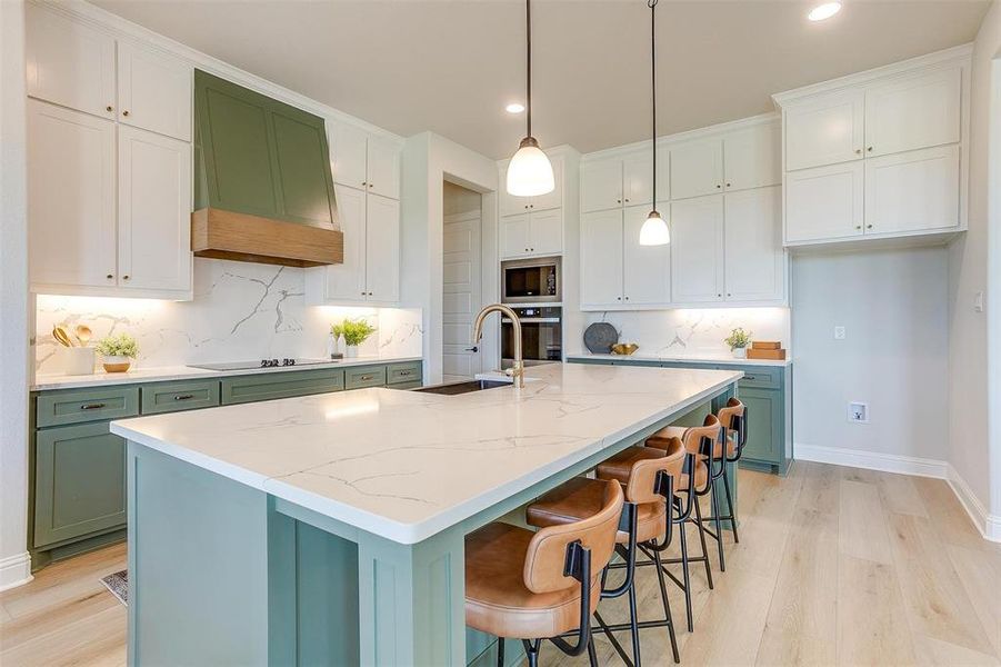 Kitchen featuring appliances with stainless steel finishes, decorative backsplash, white cabinets, and custom exhaust hood