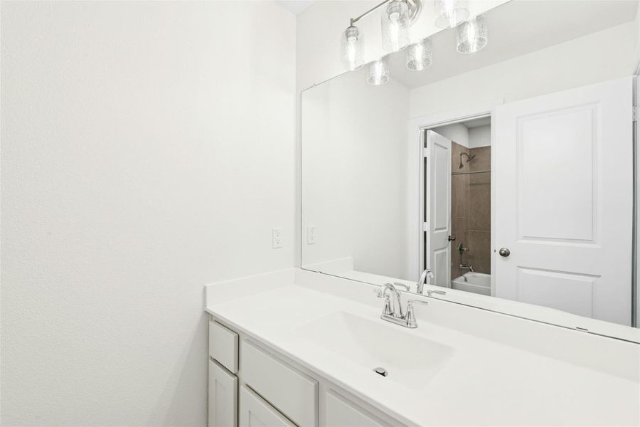 Bathroom with vanity and  shower combination