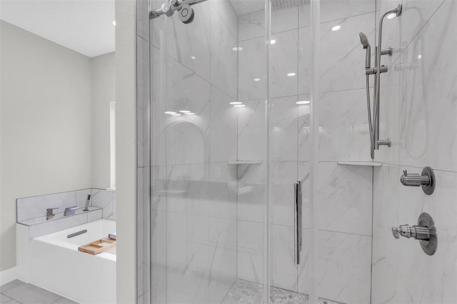 Full bathroom featuring a marble finish shower, a bath, and light tile patterned floors