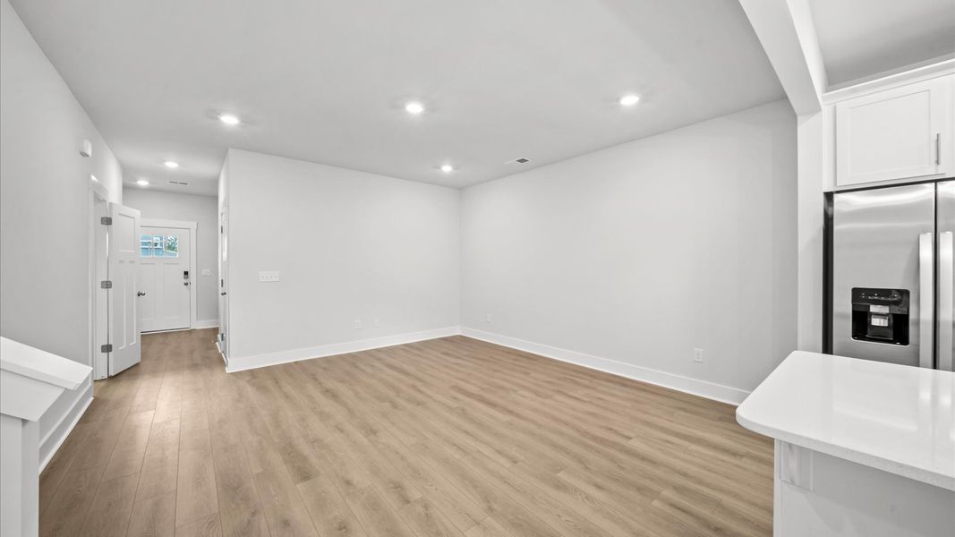 Spacious family room with rich hardwood flooring in a brand new DRB Homes build at Saluda Crossing in Piedmont, SC