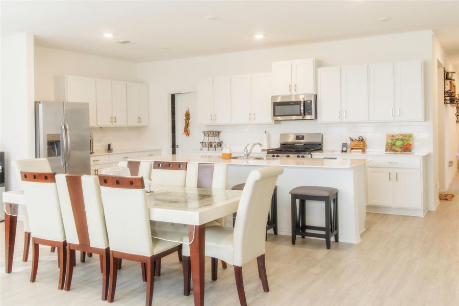 Spacious, elegant dining area seamlessly connected to the kitchen and family room for effortless entertaining.