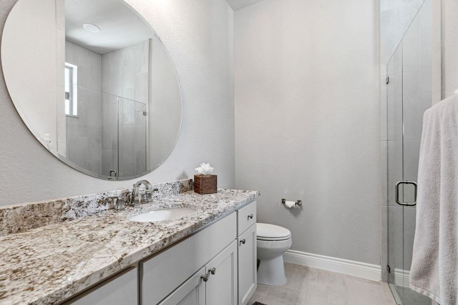 The guest bathroom features clean, modern finishes and a glass-enclosure shower. The guest bathroom features clean, modern finishes and a glass-enclosure shower.