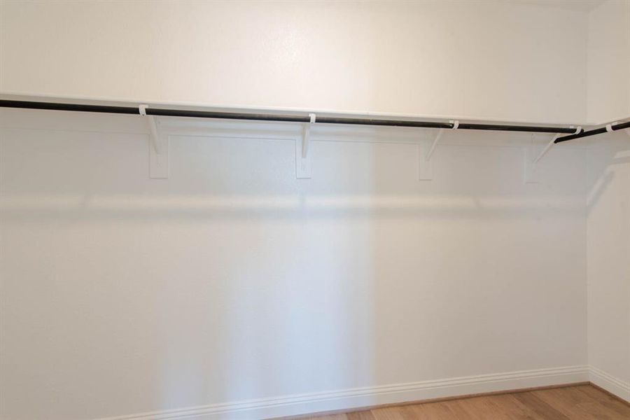 Walk in closet featuring light wood-type flooring