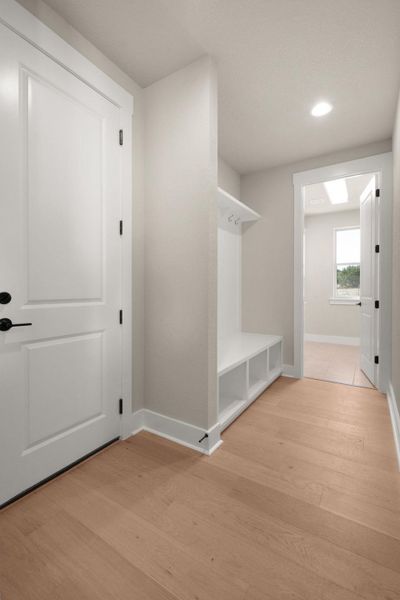 Mudroom featuring light wood-style flooring and recessed lighting