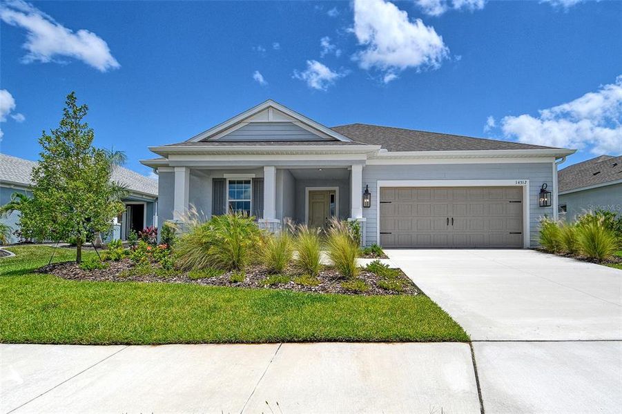 Front exterior of a new home in Canoe Creek, Parrish, FL, highlighting curb appeal (Image 1).