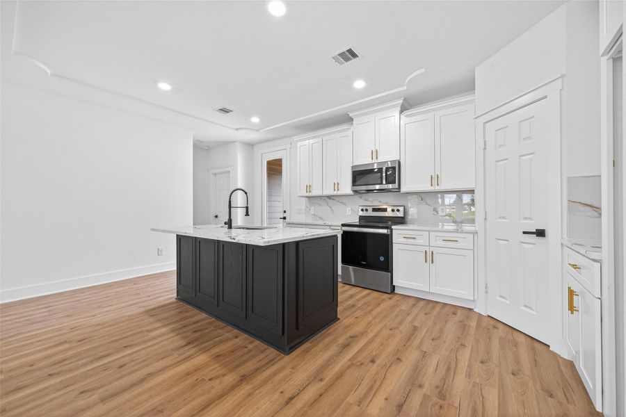 Expansive island overlooking the living area, perfect for gatherings and everyday functionality.